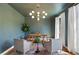 Stylish office with a unique light fixture, painted walls, and natural light from the windows at 2968 Ovalene Sw Ct, Marietta, GA 30064
