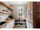 Pantry with white shelving, decorative tile floors, and a window providing natural light at 2968 Ovalene Sw Ct, Marietta, GA 30064