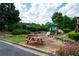 Community playground featuring a slide and climbing area with picnic tables and mature trees at 2968 Ovalene Sw Ct, Marietta, GA 30064