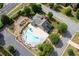 Aerial view of community pool with playground, lounge chairs, and manicured landscaping at 2968 Ovalene Sw Ct, Marietta, GA 30064