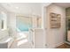 Bright hallway with bench, neutral carpet, white walls, and decorative art accents at 1882 Copelyn Reese Court (Lot 167), Lawrenceville, GA 30043