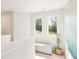 Hallway with bench and view of nature from windows at 1882 Copelyn Reese Court (Lot 167), Lawrenceville, GA 30043