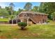Brick house with stairs, covered parking, a patio, and yard at 2320 Tilson Cir, Decatur, GA 30032