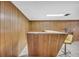 Basement bar area with wood paneling and seating at 2320 Tilson Cir, Decatur, GA 30032