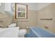 Retro bathroom featuring a sink, toilet, and blue bathtub at 2320 Tilson Cir, Decatur, GA 30032