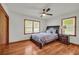 Cozy bedroom featuring hardwood floors and ample natural light from two windows at 2320 Tilson Cir, Decatur, GA 30032