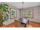 Bright dining room with wood floors, trim, and a modern chandelier at 2320 Tilson Cir, Decatur, GA 30032