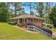 Brick house with landscaped yard, carport, and a set of stairs leading to the front door at 2320 Tilson Cir, Decatur, GA 30032