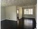 Inviting living room with wood floors and entry to the kitchen at 888 Beecher Sw Ct, Atlanta, GA 30311