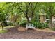 Picturesque community space featuring a white bench, mulch beds, and surrounding trees providing ample shade at 1354 Fernwood Ne Cir, Brookhaven, GA 30319