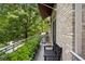 Charming deck with a stainless grill, potted greenery, and a black bench for outdoor cooking and relaxation at 1354 Fernwood Ne Cir, Brookhaven, GA 30319