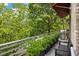 Outdoor deck featuring a stainless grill, potted greenery, and a black bench for outdoor cooking and relaxation at 1354 Fernwood Ne Cir, Brookhaven, GA 30319
