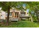 A well-maintained house with a mix of brick and siding exterior, highlighted by lush green trees and a landscaped front at 1354 Fernwood Ne Cir, Brookhaven, GA 30319