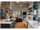 Modern kitchen with an island and stainless steel appliances open to a living area with a fireplace at 1354 Fernwood Ne Cir, Brookhaven, GA 30319