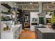 Modern kitchen boasts stainless steel appliances, open shelving, white cabinets, and seamless integration with the living space at 1354 Fernwood Ne Cir, Brookhaven, GA 30319