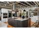 Modern kitchen with a center island and stainless steel appliances, open to an adjacent living area at 1354 Fernwood Ne Cir, Brookhaven, GA 30319