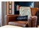 Cozy leather armchair with decorative pillows and a stylish bookshelf in a naturally lit living room at 1354 Fernwood Ne Cir, Brookhaven, GA 30319