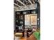 Stylish living room featuring leather armchairs, decorative shelving, brick walls, and exposed ceiling beams at 1354 Fernwood Ne Cir, Brookhaven, GA 30319
