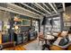 Stylish living space includes a bar area, leather seating, hardwood floors, and decorative lighting fixtures at 1354 Fernwood Ne Cir, Brookhaven, GA 30319