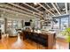 Open concept living space with kitchen island, hardwood floors, fireplace, and exposed ceiling beams at 1354 Fernwood Ne Cir, Brookhaven, GA 30319