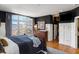 Bright main bedroom with large windows, dark accent walls, and hardwood floors for a cozy atmosphere at 1354 Fernwood Ne Cir, Brookhaven, GA 30319