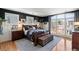 Comfortable main bedroom featuring large windows, wood floors, and stylish furnishings at 1354 Fernwood Ne Cir, Brookhaven, GA 30319