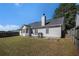 Backyard view of home featuring a large, grassy lawn and a fenced perimeter at 257 Se Ashland Park Se Ct, Lawrenceville, GA 30045