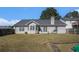 Backyard view of home featuring a large, grassy lawn and a fenced perimeter at 257 Se Ashland Park Se Ct, Lawrenceville, GA 30045