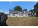 Backyard view of home featuring a large, grassy lawn and a fenced perimeter at 257 Se Ashland Park Se Ct, Lawrenceville, GA 30045
