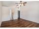 Bedroom featuring beautiful hardwood floors, a ceiling fan, and an attached bathroom at 257 Se Ashland Park Se Ct, Lawrenceville, GA 30045