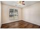 Bedroom with ceiling fan, window, and updated flooring at 257 Se Ashland Park Se Ct, Lawrenceville, GA 30045