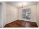 Empty dining room with warm wood floors, neutral walls, and a chandelier at 257 Se Ashland Park Se Ct, Lawrenceville, GA 30045