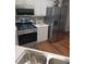Well-equipped kitchen with modern stainless steel appliances, white cabinets, and a double sink at 257 Se Ashland Park Se Ct, Lawrenceville, GA 30045