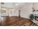 Open-concept living area with wood floors, a fireplace, and an abundance of natural light at 257 Se Ashland Park Se Ct, Lawrenceville, GA 30045