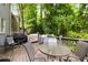 Back deck with outdoor dining and grilling area, set against a scenic wooded backdrop at 3227 Collier Gate Se Ct, Smyrna, GA 30080