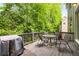 Back deck is ideal for entertaining, complete with a grill and dining set against a wooded backdrop at 3227 Collier Gate Se Ct, Smyrna, GA 30080