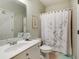 Bathroom featuring white vanity, toilet, and shower with patterned curtain at 3227 Collier Gate Se Ct, Smyrna, GA 30080