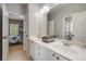 Bright bathroom featuring a double vanity, white cabinets, and a view into the bedroom at 3227 Collier Gate Se Ct, Smyrna, GA 30080
