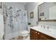 Bright bathroom featuring a shower with modern fixtures and stylish floral shower curtain at 3227 Collier Gate Se Ct, Smyrna, GA 30080