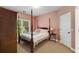 Bedroom featuring a four-poster bed, pink walls, carpet and a view out the window at 3227 Collier Gate Se Ct, Smyrna, GA 30080