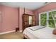 Bedroom with pink walls, carpet, a bed, and a view out the window at 3227 Collier Gate Se Ct, Smyrna, GA 30080