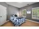 Cozy bedroom featuring a window with plantation shutters and carpeted floors at 3227 Collier Gate Se Ct, Smyrna, GA 30080