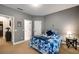 Comfortable bedroom featuring neutral walls, carpet, a blue floral comforter, and doors to closet and hall at 3227 Collier Gate Se Ct, Smyrna, GA 30080
