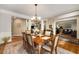 Elegant dining room with a wooden table, chandelier, and views into the living room at 3227 Collier Gate Se Ct, Smyrna, GA 30080