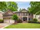 Charming two-story brick home with a two-car garage and a beautifully landscaped front yard at 3227 Collier Gate Se Ct, Smyrna, GA 30080
