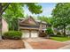 Inviting brick home with an attached two-car garage and a manicured lawn with trees at 3227 Collier Gate Se Ct, Smyrna, GA 30080