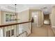 Hallway with chandelier, crown molding, and staircase leading to the first floor at 3227 Collier Gate Se Ct, Smyrna, GA 30080