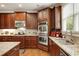 Open-concept kitchen features stainless steel appliances, granite countertops, and ample cabinet space at 3227 Collier Gate Se Ct, Smyrna, GA 30080