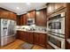 Lovely kitchen features stainless appliances, granite counters, hardwood floors and breakfast bar at 3227 Collier Gate Se Ct, Smyrna, GA 30080