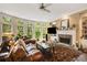 Bright living room with large windows, a fireplace, and ample seating, perfect for relaxation or entertaining at 3227 Collier Gate Se Ct, Smyrna, GA 30080